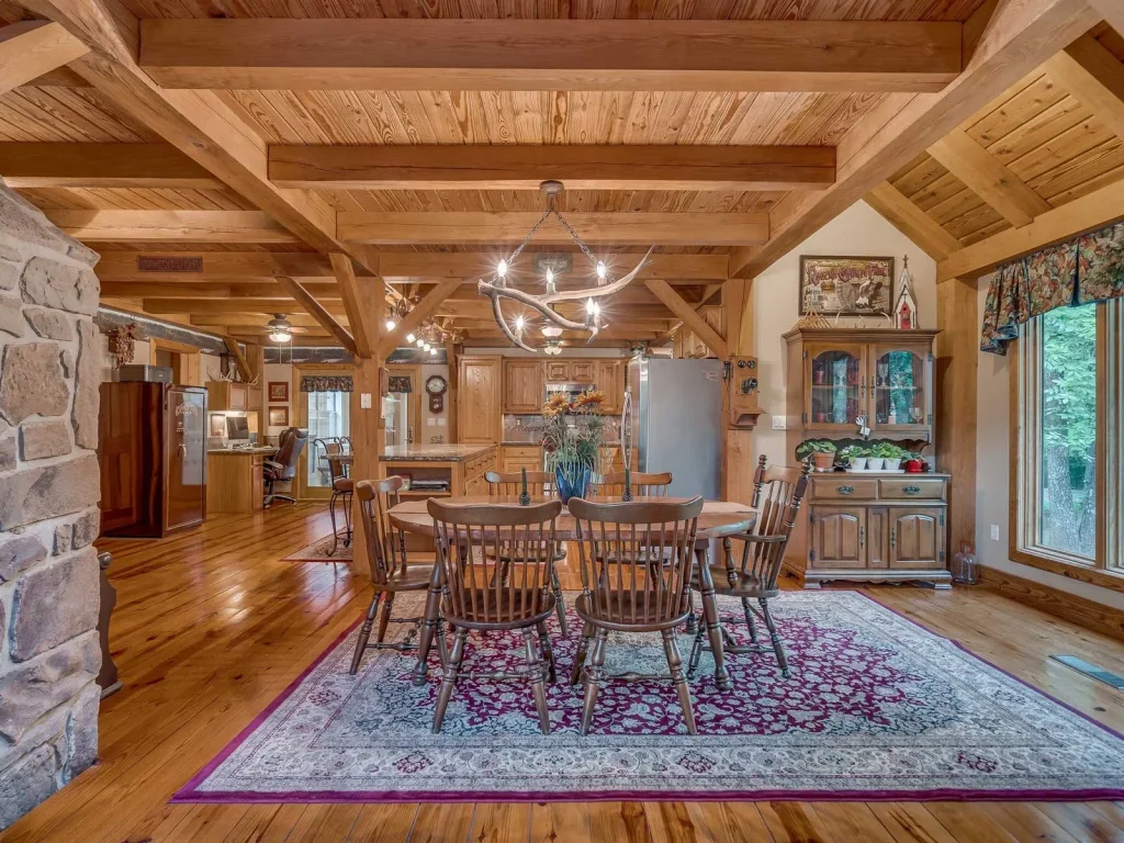 Timber frame dining room with beamed pine ceiling and stone wall