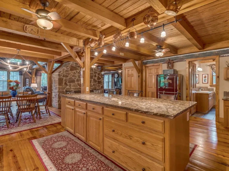 Timber frame kitchen with wood cabinets, granite island and pine ceiling