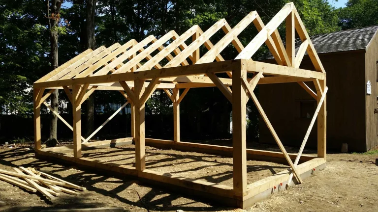 Timber frame garage with full rafters and diagonal bracing on a sill