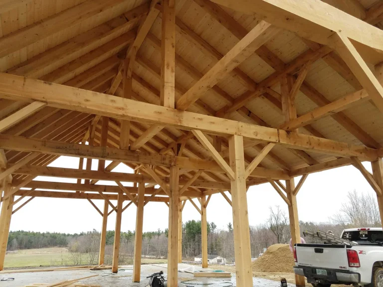 Open timber frame pavilion with king post trusses and braced posts