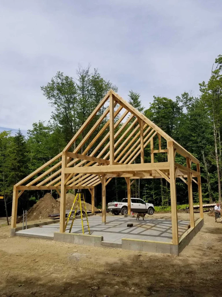 Timber frame garage with king post truss raised on a concrete slab