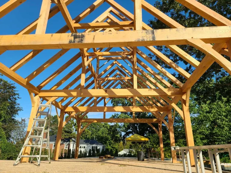 Timber frame pavilion with tie beams and rafters seen from inside