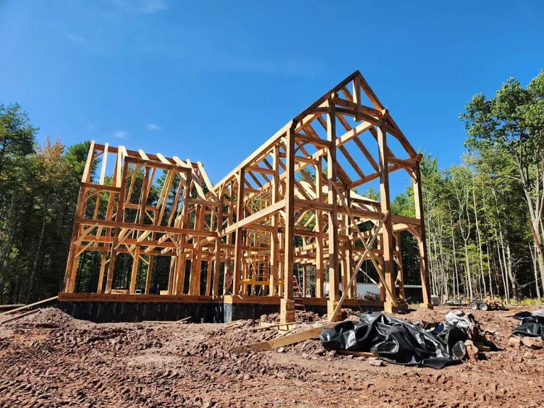 Timber frame home with tall center gable rising above the foundation