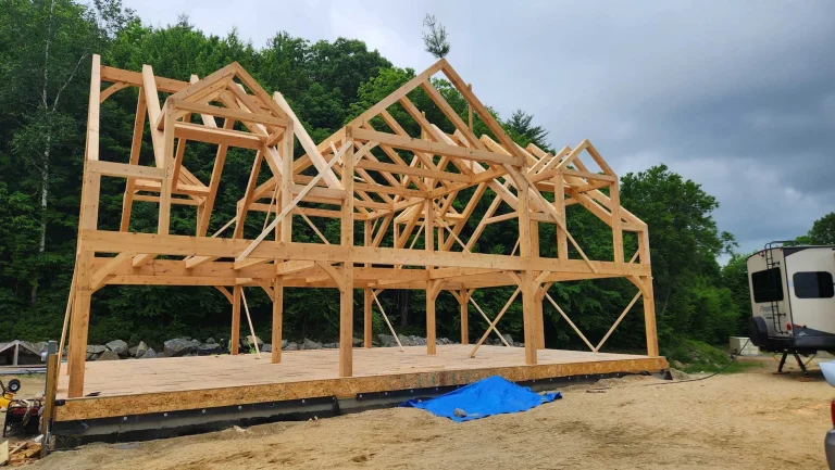 Timber frame home with dormers and gables raised on a subfloor